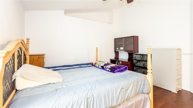 bedroom featuring lofted ceiling, dark wood-type flooring, and ceiling fan