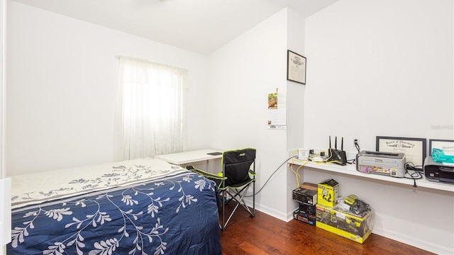 bedroom featuring lofted ceiling and dark wood-type flooring