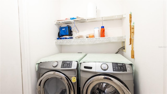 washroom featuring washing machine and dryer