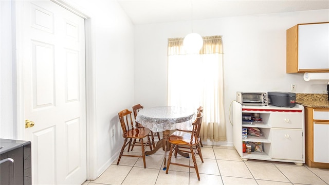 dining space featuring light tile patterned floors