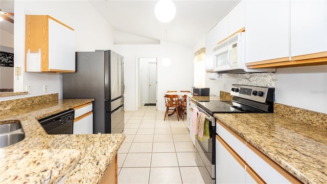 kitchen featuring vaulted ceiling, light tile patterned floors, appliances with stainless steel finishes, light stone countertops, and white cabinets