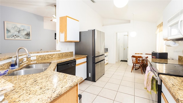 kitchen with lofted ceiling, sink, stainless steel appliances, light stone countertops, and white cabinets