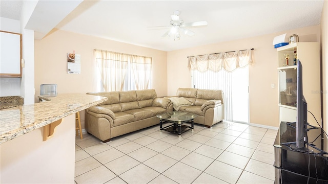 living room with light tile patterned floors and ceiling fan