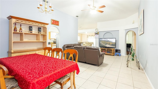 dining space with light tile patterned floors and ceiling fan with notable chandelier