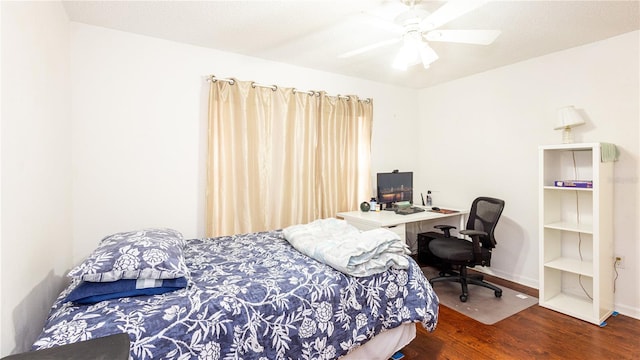 bedroom with dark wood-type flooring and ceiling fan