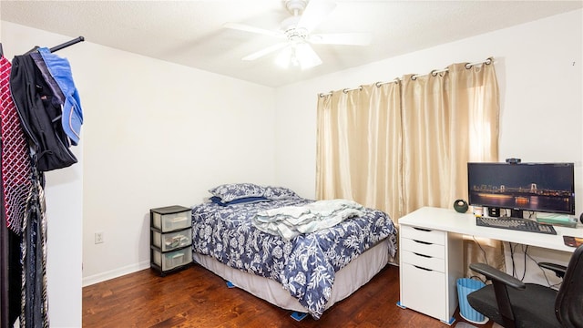 bedroom featuring ceiling fan, dark hardwood / wood-style floors, and a textured ceiling