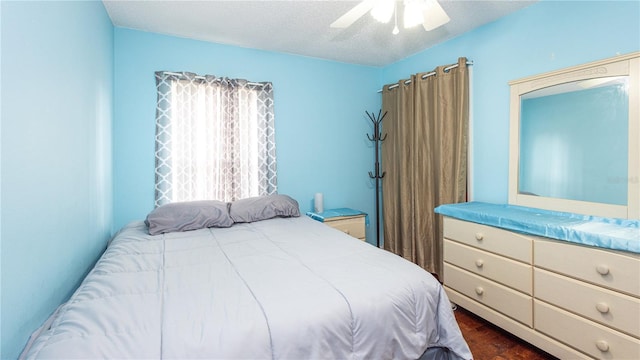 bedroom featuring a textured ceiling and ceiling fan