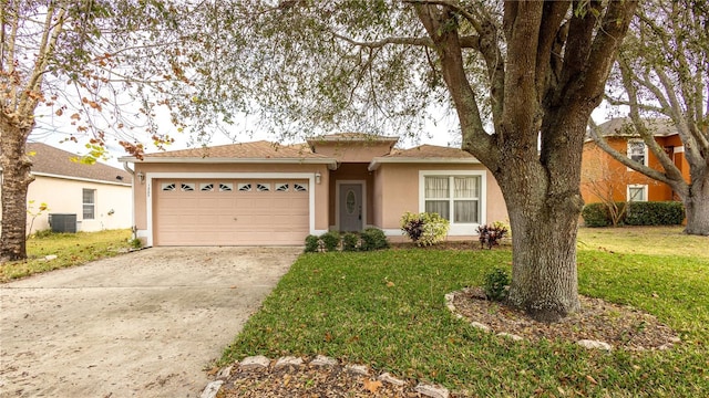 view of front of home with central AC unit, a garage, and a front yard