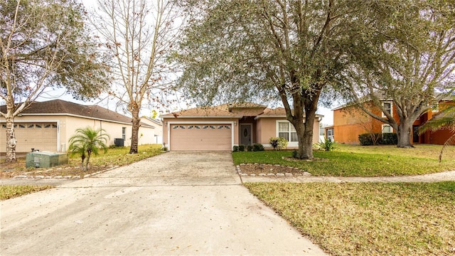 view of front of home featuring a garage and a front lawn