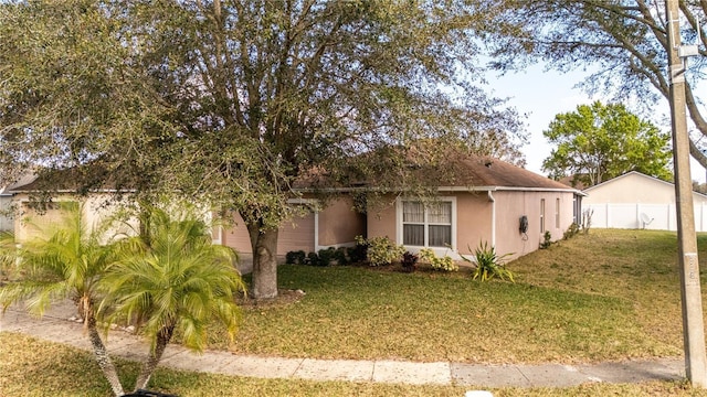 view of side of home with a yard