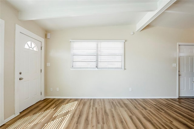 entryway featuring lofted ceiling with beams, baseboards, and wood finished floors