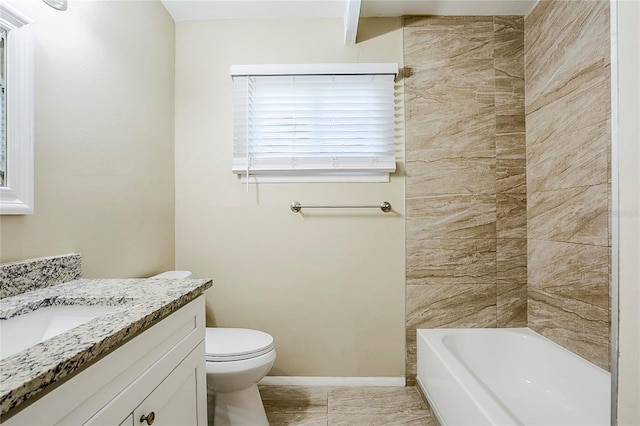 bathroom with vanity, toilet, and baseboards