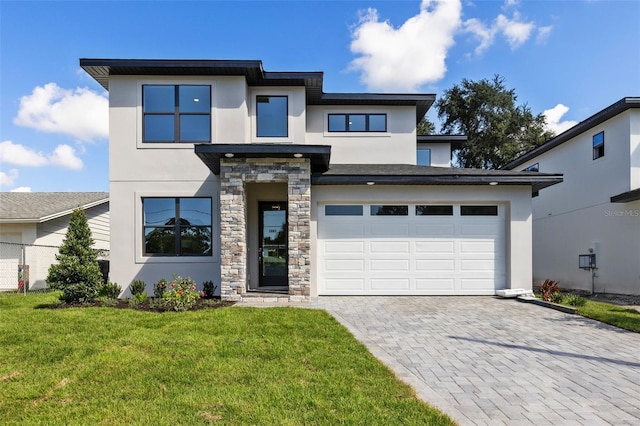 view of front of house with a garage and a front lawn