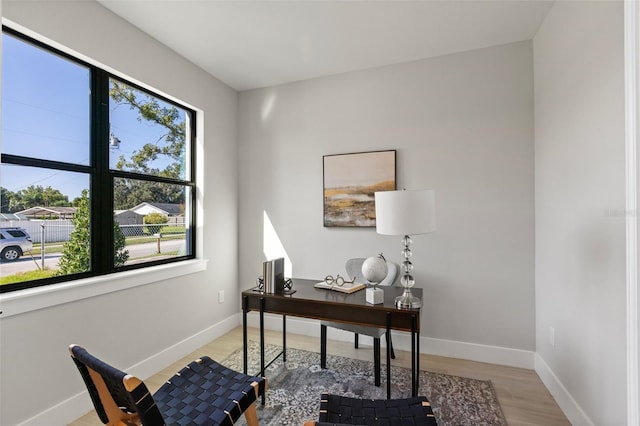 home office with light hardwood / wood-style flooring