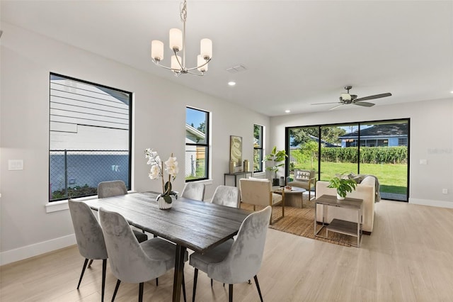 dining space featuring plenty of natural light, a chandelier, and light wood-type flooring