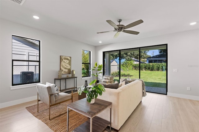 living room with ceiling fan and light wood-type flooring