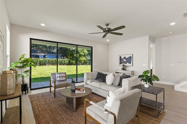 living room featuring ceiling fan and light wood-type flooring