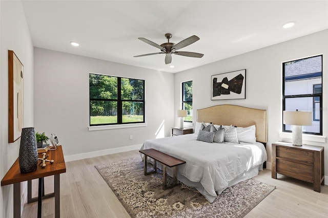 bedroom featuring light hardwood / wood-style floors and ceiling fan