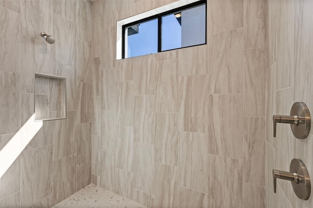 bathroom with tiled shower