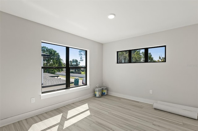 spare room with light hardwood / wood-style flooring