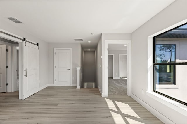 interior space featuring a barn door and light wood-type flooring