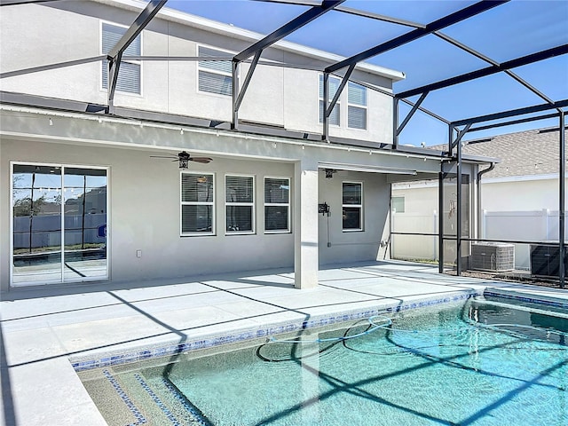 view of swimming pool with a lanai, a patio area, and ceiling fan