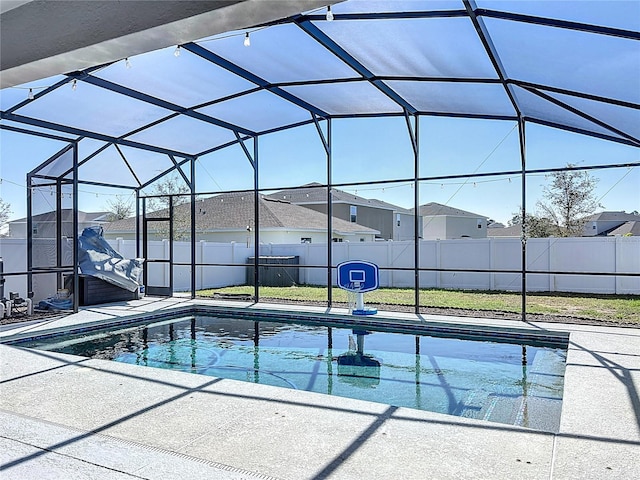 view of pool with a patio and glass enclosure