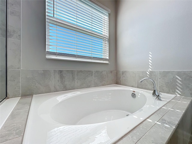 bathroom featuring a relaxing tiled tub