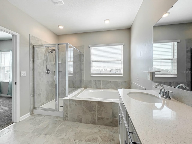 bathroom with vanity and independent shower and bath