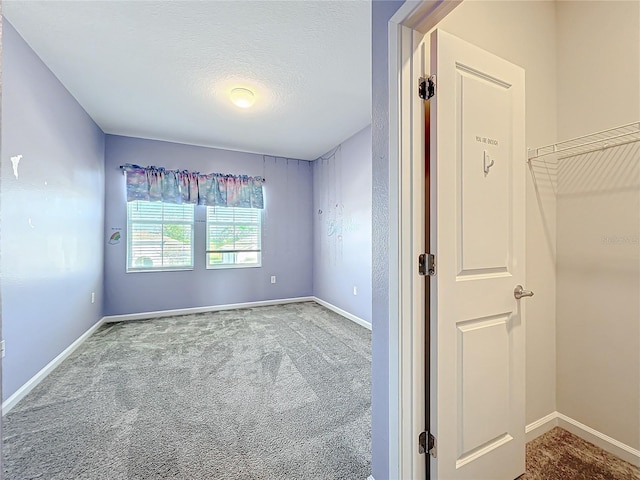 unfurnished bedroom featuring carpet flooring and a textured ceiling