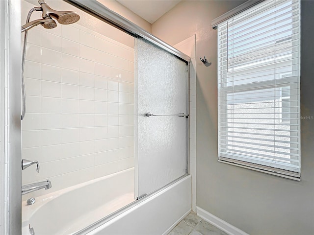 bathroom with shower / bath combination with glass door