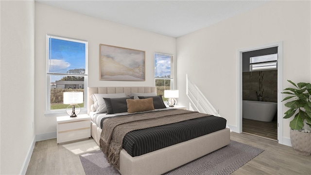 bedroom with light hardwood / wood-style flooring and ensuite bathroom