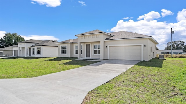 view of front facade featuring a garage, central AC unit, and a front yard