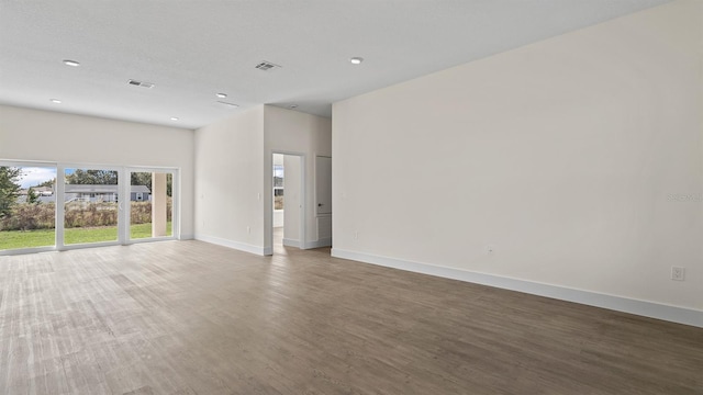 spare room featuring dark hardwood / wood-style floors