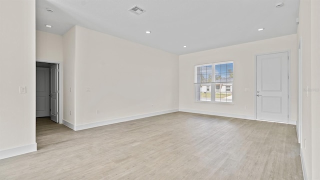 empty room with light hardwood / wood-style flooring