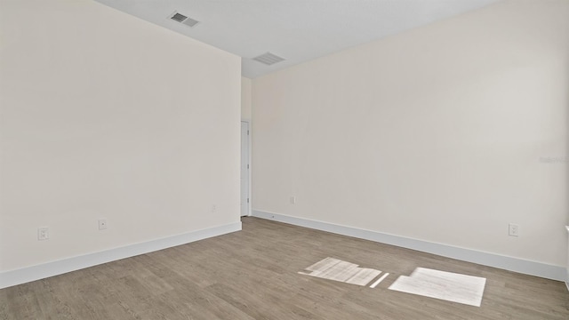 spare room featuring light hardwood / wood-style floors