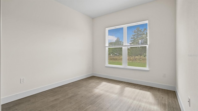 unfurnished room featuring hardwood / wood-style flooring