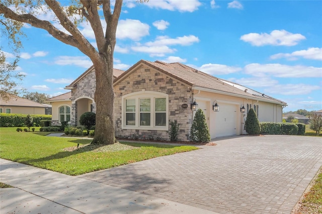 view of front of house with a garage and a front yard