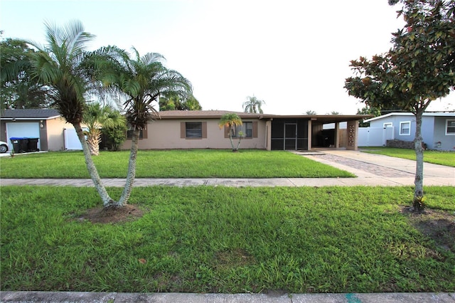 ranch-style home with a carport and a front lawn