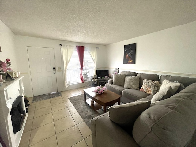 living area featuring light tile patterned floors and a textured ceiling