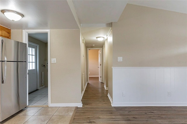 hall featuring baseboards and light wood-style floors