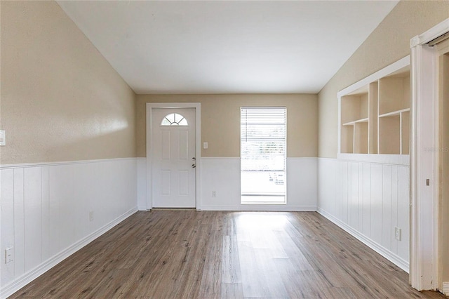 foyer entrance featuring a wainscoted wall and wood finished floors