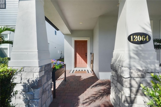 entrance to property featuring stucco siding