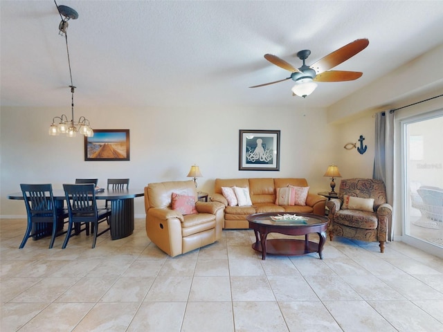 tiled living room featuring ceiling fan with notable chandelier and a textured ceiling