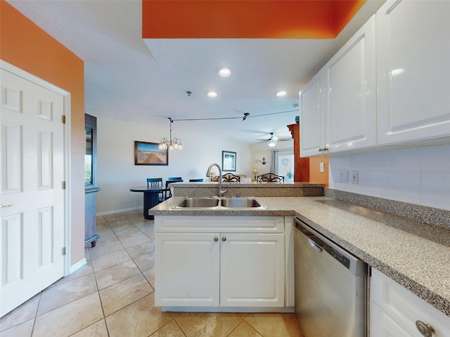 kitchen with sink, dishwasher, white cabinets, ceiling fan with notable chandelier, and kitchen peninsula