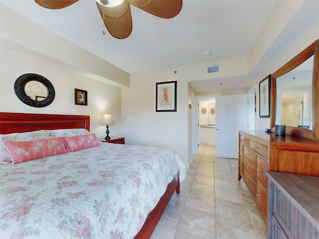 bedroom featuring ensuite bathroom and light tile patterned floors