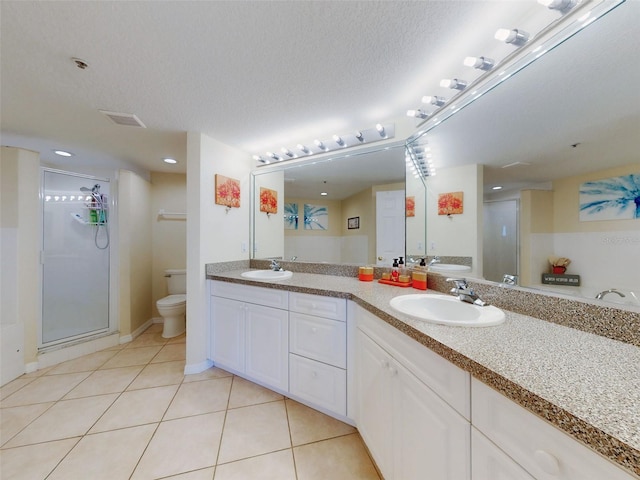 bathroom featuring vanity, tile patterned floors, toilet, and a textured ceiling