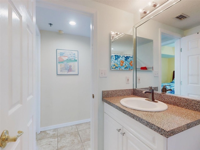 bathroom with vanity and tile patterned flooring