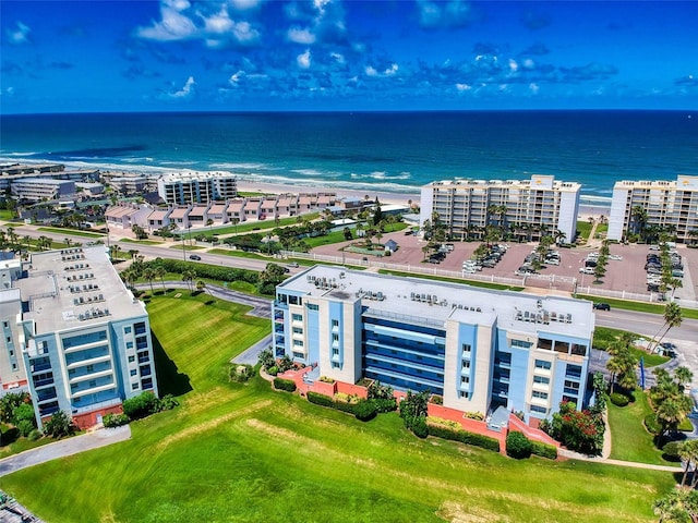 drone / aerial view featuring a water view and a beach view