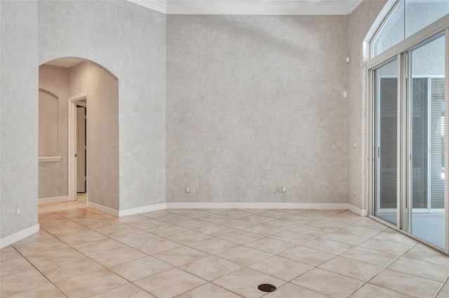 empty room featuring a high ceiling and ornamental molding